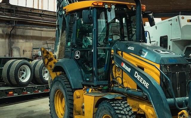 A backhoe loader in for service on the Mach 6 shop floor