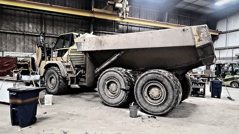 CAT rock truck serviced in the Mach 6 shop bay