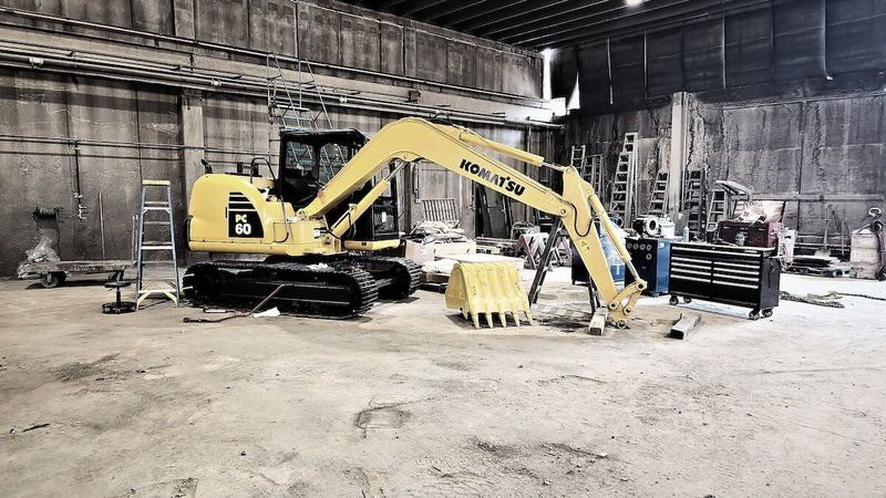 Komatsu excavator inside the Mach 6 shop bay