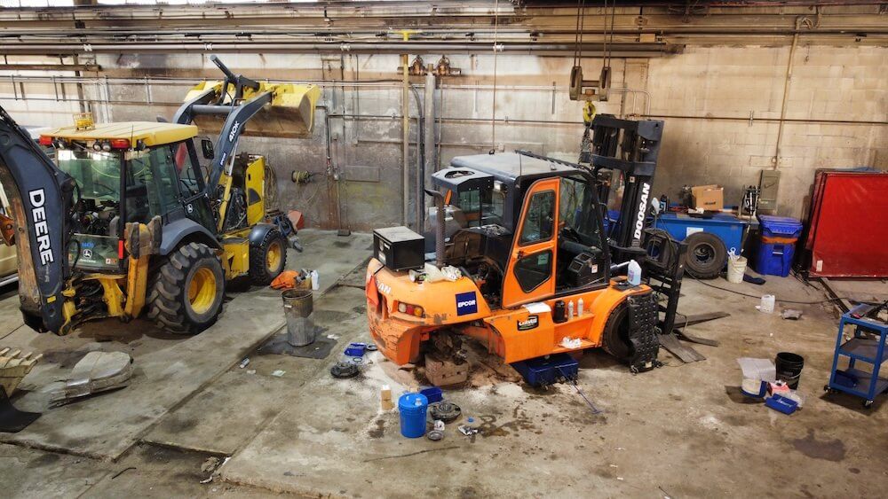 Construction equipment inside the Mach 6 Edmonton service bay