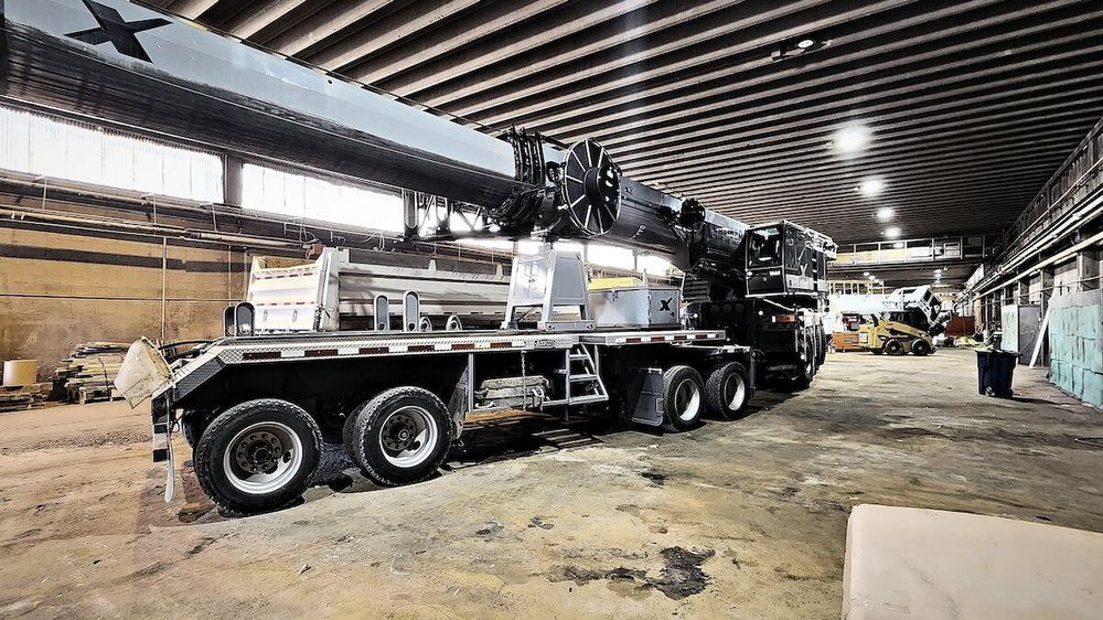 Tri-drive picker truck with boom stowed inside the Mach 6 shop bay