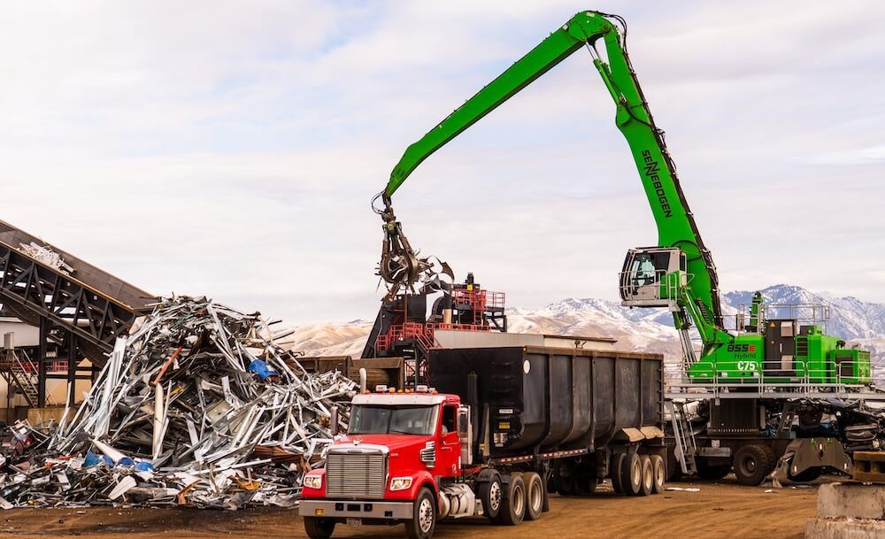 Manufacturer photo of a Sennebogen material handler, wheeled machine, outdoors in a scrap yard