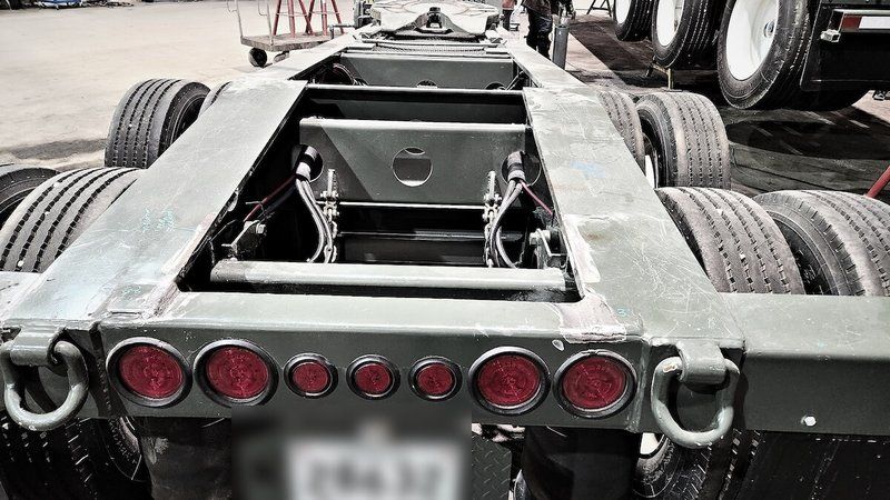 Trailer rear light bar and seven-way electrical connection area in the Mach 6 shop, licence plate blurred