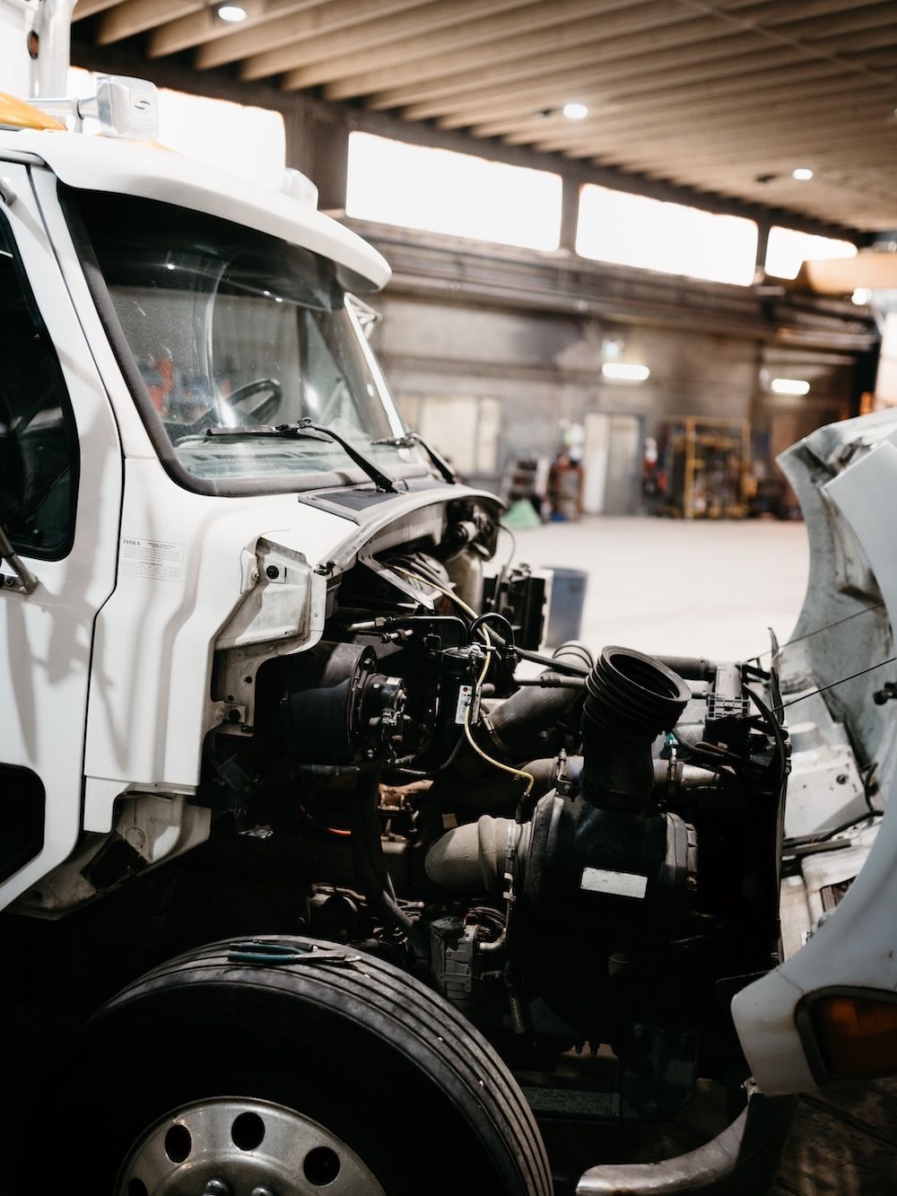 Commercial truck with its hood open in the Mach 6 service bay